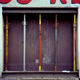 photograph of a door in Paris propped up with coloured poles